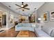 Spacious open-concept living area showcasing hardwood floors, a comfortable seating area, and seamless flow to the kitchen at 2418 Ridgemooor Dr, Orlando, FL 32828