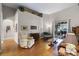 Bright living room featuring neutral walls, wood floors, vaulted ceilings, and a sliding glass door to the outdoor patio at 2418 Ridgemooor Dr, Orlando, FL 32828