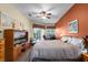 Comfortable main bedroom with neutral tones, complemented by ample natural light and a ceiling fan for comfortable living at 2418 Ridgemooor Dr, Orlando, FL 32828