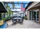 Relaxing screened-in patio with stone flooring and views of the beautifully landscaped backyard at 2418 Ridgemooor Dr, Orlando, FL 32828
