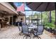 Inviting screened patio with ample seating beneath an umbrella, adjacent to a cozy bar area for relaxation and entertainment at 2418 Ridgemooor Dr, Orlando, FL 32828