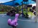 Outdoor playground with a purple dino and a soft, blue surface for to play on at 2418 Ridgemooor Dr, Orlando, FL 32828