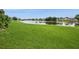 Expansive backyard with lush green grass and stunning water views at 2501 Grassy Point Dr # 107, Lake Mary, FL 32746