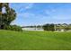 Expansive backyard with lush green grass and stunning water views at 2501 Grassy Point Dr # 107, Lake Mary, FL 32746