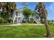Inviting exterior featuring a well-maintained blue condo with lush landscaping and a staircase leading to the entrance at 2501 Grassy Point Dr # 107, Lake Mary, FL 32746