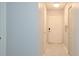 Bright hallway featuring a front door, neutral walls, and neutral flooring at 2501 Grassy Point Dr # 107, Lake Mary, FL 32746