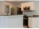 Updated kitchen features granite countertops, stainless steel appliances, and plenty of cabinet space at 2501 Grassy Point Dr # 107, Lake Mary, FL 32746