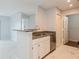 Bright kitchen features granite countertops, stainless steel dishwasher, and white cabinets at 2501 Grassy Point Dr # 107, Lake Mary, FL 32746