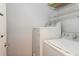 Laundry Room including a washer, dryer and wire shelving at 2501 Grassy Point Dr # 107, Lake Mary, FL 32746