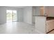 Bright living room with a sliding glass door, lake view, and adjacent kitchen at 2501 Grassy Point Dr # 107, Lake Mary, FL 32746