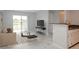 Open living room with a large window, neutral finishes, and adjacent kitchen at 2501 Grassy Point Dr # 107, Lake Mary, FL 32746