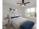 Inviting bedroom featuring a queen-sized bed, ceiling fan, and a window at 2501 Grassy Point Dr # 107, Lake Mary, FL 32746
