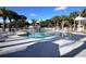 Enjoy a community swimming pool surrounded by lush greenery and seating at 2501 Grassy Point Dr # 107, Lake Mary, FL 32746