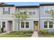 Charming townhouse with blue siding, tidy landscaping, and a welcoming yellow front door at 3028 Water Sprite St, Orlando, FL 32808