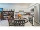 Bright kitchen with white cabinetry, granite counters, stainless appliances, and a breakfast nook at 3028 Water Sprite St, Orlando, FL 32808