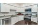 Modern kitchen featuring granite counters, stainless steel appliances and bright white cabinetry at 3028 Water Sprite St, Orlando, FL 32808