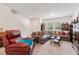 Spacious living room, furnished with a plush sectional and a cozy recliner, bathed in natural light at 3028 Water Sprite St, Orlando, FL 32808