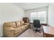 Versatile room featuring couch and desk, ideal for a home office or den at 3028 Water Sprite St, Orlando, FL 32808