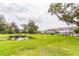 Scenic view of a community pond surrounded by lush greenery and townhome exteriors at 3028 Water Sprite St, Orlando, FL 32808