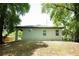 Backyard view of the home featuring a grassy area, new roof, and exterior paint at 309 E 13Th St, Apopka, FL 32703