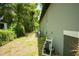 Backyard with AC unit, green hose, and room for lawn furniture at 309 E 13Th St, Apopka, FL 32703