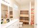 Bright bathroom featuring a double vanity and a shower with decorative curtains at 309 E 13Th St, Apopka, FL 32703