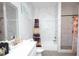 Bathroom with marble style tiled walls, neutral colored bath curtain, and shower at 309 E 13Th St, Apopka, FL 32703