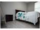 Bedroom with wood-look tile floor features a wooden headboard bed and nightstand at 309 E 13Th St, Apopka, FL 32703