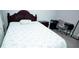 Bedroom with wood-look tile floor features a wooden headboard bed and desk at 309 E 13Th St, Apopka, FL 32703