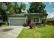 Charming single-story home features a gray exterior, brick driveway, and well-maintained landscaping at 309 E 13Th St, Apopka, FL 32703