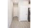 Hallway with wood-look floors and white doors, connecting various rooms in the house at 309 E 13Th St, Apopka, FL 32703