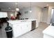 Bright kitchen with a large island, stainless steel appliances, and tile flooring at 309 E 13Th St, Apopka, FL 32703