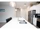 Bright kitchen with a white countertop island with a sink and stainless steel appliances at 309 E 13Th St, Apopka, FL 32703