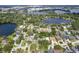 A breathtaking aerial shot of a lakeside neighborhood featuring homes nestled among lush greenery and tranquil waters at 3535 Lake Sarah Dr, Orlando, FL 32804