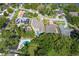 A picturesque aerial view showcases a neighborhood with lush landscaping and sparkling swimming pools at 3535 Lake Sarah Dr, Orlando, FL 32804