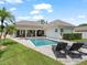 A well-maintained backyard features a pool and a lush green lawn at 3535 Lake Sarah Dr, Orlando, FL 32804