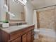 Bathroom featuring a shower/tub combo, tile, and a vanity with a large mirror at 3535 Lake Sarah Dr, Orlando, FL 32804