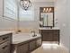 Luxurious bathroom featuring a soaking tub, elegant vanity, and modern fixtures at 3535 Lake Sarah Dr, Orlando, FL 32804