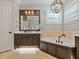 Bathroom featuring a tub, window with blinds, and vanity with dark wood at 3535 Lake Sarah Dr, Orlando, FL 32804