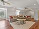 Spacious bonus room with cozy seating area, two ceiling fans, and great natural light at 3535 Lake Sarah Dr, Orlando, FL 32804
