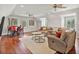 Bonus room offers hardwood floors, modern seating, media center, and eat-in table at 3535 Lake Sarah Dr, Orlando, FL 32804