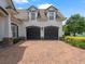 Charming home with a two-car garage, brick driveway, manicured landscaping, and a neutral paint scheme at 3535 Lake Sarah Dr, Orlando, FL 32804