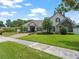 Beautiful home featuring a paver driveway, well-manicured lawn and charming curb appeal at 3535 Lake Sarah Dr, Orlando, FL 32804