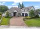 Charming two-story home features a paver driveway, three-car garage and manicured landscaping at 3535 Lake Sarah Dr, Orlando, FL 32804