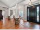 Elegant foyer boasts hardwood flooring, stone-clad columns, and a stylish front door with decorative glass sidelights at 3535 Lake Sarah Dr, Orlando, FL 32804