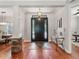 Elegant foyer with hardwood floors, decorative lighting, and a view of the dining room at 3535 Lake Sarah Dr, Orlando, FL 32804