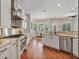 Modern kitchen featuring white cabinetry, stainless steel appliances, and hardwood flooring at 3535 Lake Sarah Dr, Orlando, FL 32804