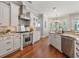 Chef's kitchen featuring custom cabinetry, stainless steel appliances, and an adjacent dining area at 3535 Lake Sarah Dr, Orlando, FL 32804