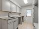 Convenient laundry room with cabinets, a countertop, utility sink, and access to the exterior at 3535 Lake Sarah Dr, Orlando, FL 32804