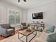 Comfortable living room features a ceiling fan and a large rug at 3535 Lake Sarah Dr, Orlando, FL 32804